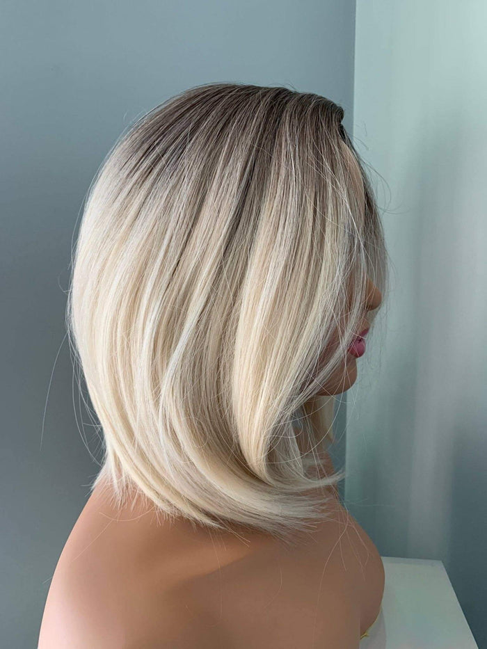 Sadie Short Blonde Rooted Wig showcasing a sleek bob with a soft angled cut and a polished finish.
