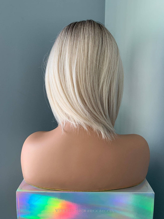 Back view of Sadie Short Blonde Rooted Wig, showcasing sleek bob cut and face-framing silhouette.