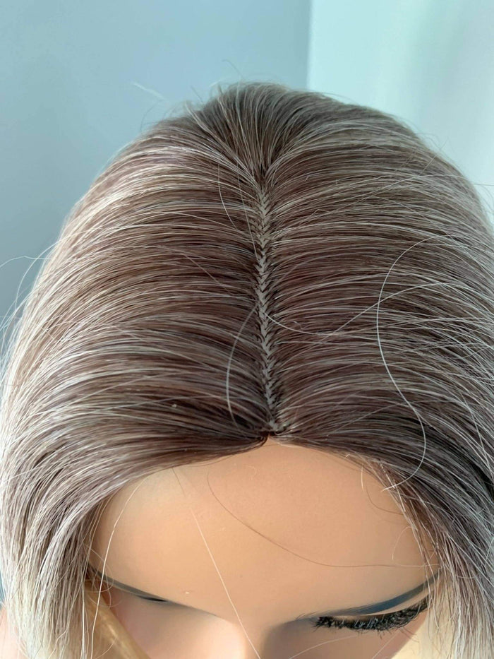 Close-up of the top view of the Sadie Short Blonde Rooted Wig showing the sleek, blended hair colors and centre part.