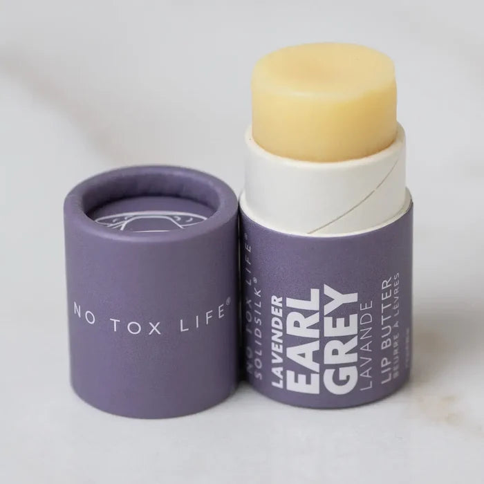 Lavender Earl Grey lip balm with packaging on a white background