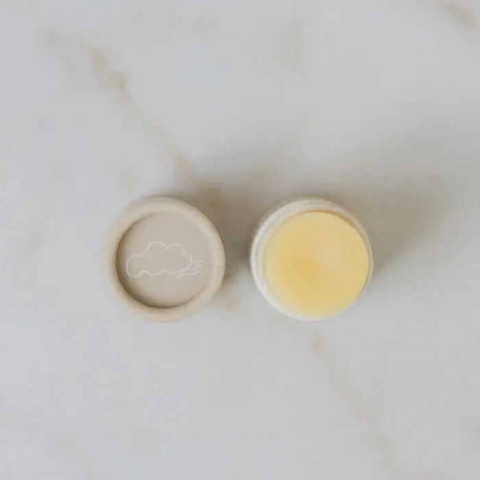 Two small containers with a cloud design on a marble surface