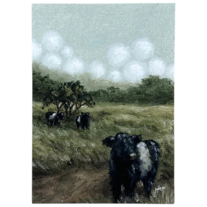 The SOPHIE WYATT STUDIO - BELTIES ART PRINT, 12X16 by SOPHIE WYATT STUDIO features a tranquil countryside scene with Belted Galloway cows peacefully grazing in a grassy field beneath a cloudy sky, surrounded by trees and bushes—a perfect art print to add rural charm to any space.