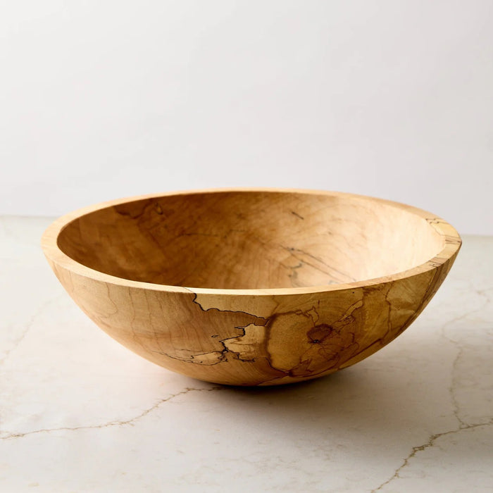 A handcrafted SPENCER PETERMAN - SPALTED MAPLE BOWL 13" by PETERMANS BOARDS & BOWLS INC, featuring a round shape with a light, natural finish and striking spalted maple grain patterns, displayed on a white background.