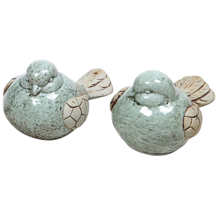 The CREATIVE COOP STONEWARE BIRD set features two stoneware bird figurines with pale green bodies, beige wings and tails, finished with a subtle reactive glaze—a charming accent for any space.