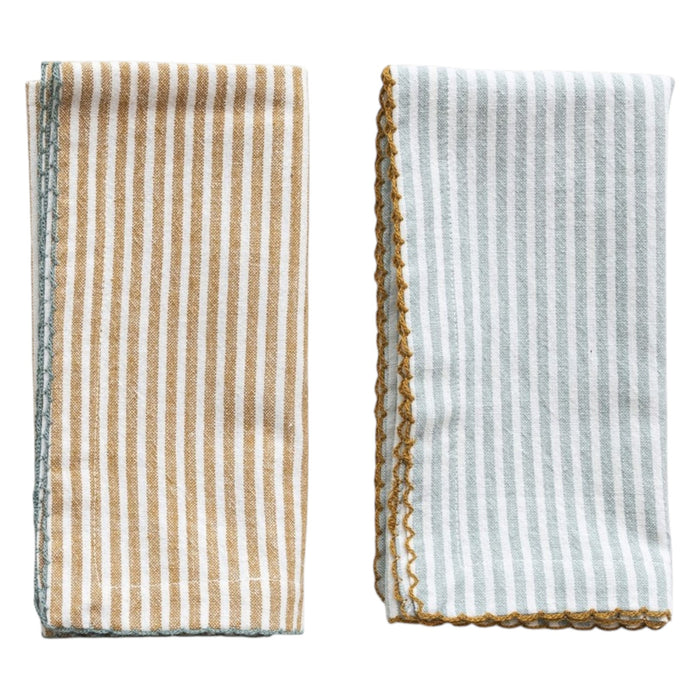 The CREATIVE COOP STRIPED COTTON NAPKIN WITH SCALLOP TRIM comes in aqua or mustard. Each 18" reusable napkin adds a stylish touch to your table linens collection.