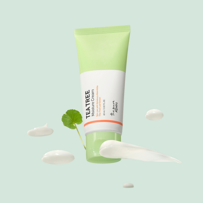 Tea tree moisture cream tube with cream swatches on a light green background