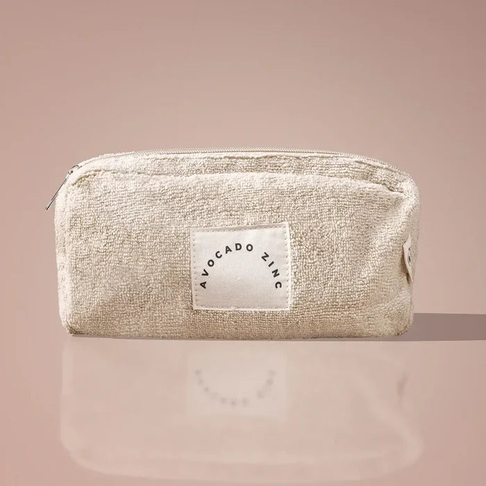 Beige pouch with a label on a beige background