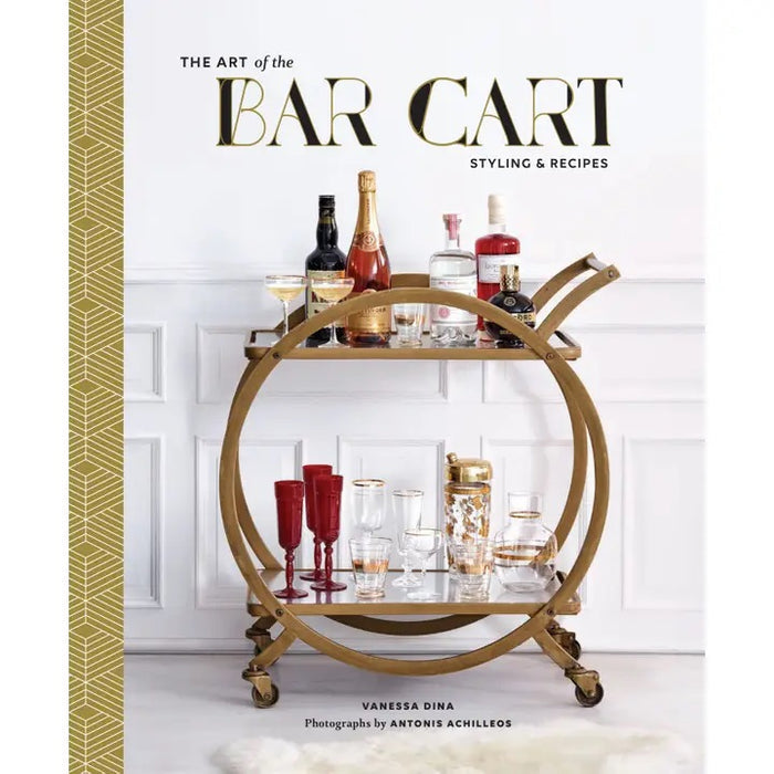 A close-up of THE ART OF THE BAR CART BY VANESSA DINA from CHRONICLE BOOKS, featuring a gold-patterned spine and an illustrated bar cart on the cover—ideal for drink ideas and elegant home bar decor.