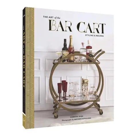 A close-up of THE ART OF THE BAR CART BY VANESSA DINA from CHRONICLE BOOKS, featuring a gold-patterned spine and an illustrated bar cart on the cover—ideal for drink ideas and elegant home bar decor.