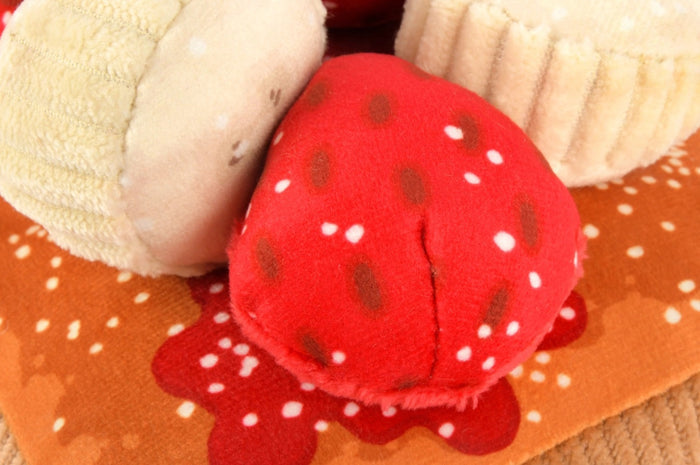 The THICK ‘N FLUFFY FRENCH TOAST DOG TOY by PLAY PET LIFESTYLES/BRANDS is a plush, squeaky dog toy designed to look like a delicious stack of French toast, topped with fabric strawberries, bananas, and syrup. Its soft texture and detailed brown edges resemble a real breakfast treat—perfect for pets who love an eco-friendly toy that looks good enough to eat.