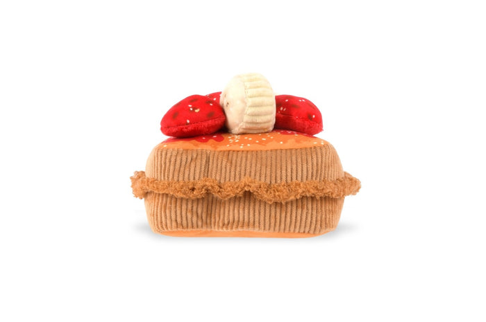 The THICK ‘N FLUFFY FRENCH TOAST DOG TOY by PLAY PET LIFESTYLES/BRANDS is a plush, squeaky dog toy designed to look like a delicious stack of French toast, topped with fabric strawberries, bananas, and syrup. Its soft texture and detailed brown edges resemble a real breakfast treat—perfect for pets who love an eco-friendly toy that looks good enough to eat.