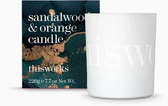 This Works Sandalwood & Orange Scented Candle 220g in a white jar with luxurious packaging.