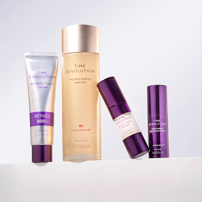 A collection of Missha skincare products including a time revolution serum, a night repair cream, a first essence enriched emulsion, and a balm stick, all displayed against a neutral background.