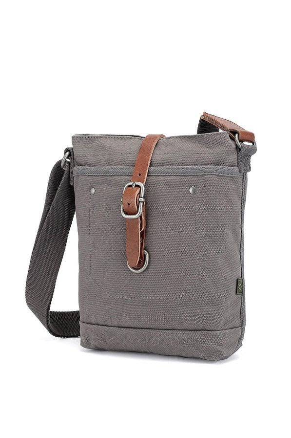 The TSD BRAND Forest Zip Crossbody Bag in Grey features a wide black strap, brown leather buckle accent, metal rivets, and a subtle side logo tag for a military-inspired look.