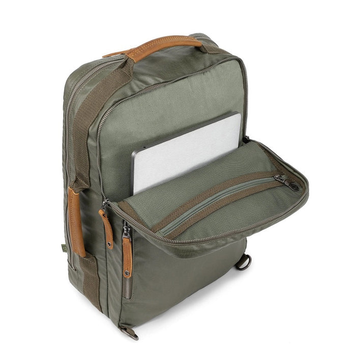 The TSD BRAND Madrone Coated Canvas Backpack in army green features brown leather accents, zippers, a top flap, side handles, metal rings, and a leather logo patch; shown lying flat to display these details.
