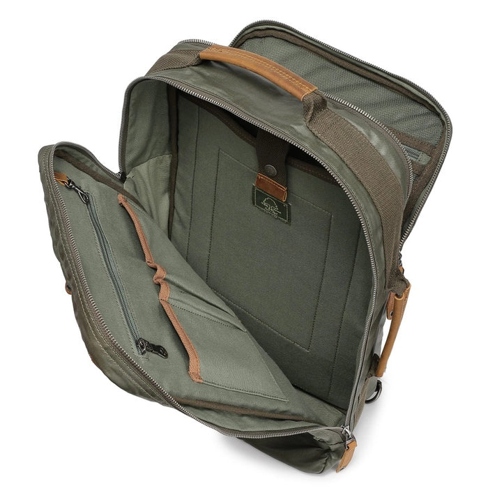 The TSD BRAND Madrone Coated Canvas Backpack in army green features brown leather accents, zippers, a top flap, side handles, metal rings, and a leather logo patch; shown lying flat to display these details.