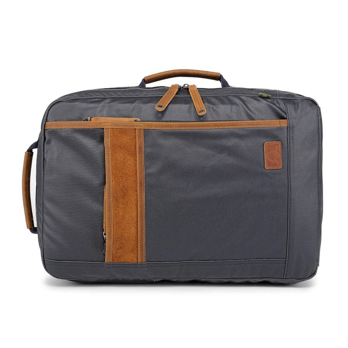 The TSD BRAND - MADRONE COATED CANVAS BACKPACK IN NAVY features brown leather accents, a spacious main compartment, a padded laptop sleeve with snap closure, and multiple zippered pockets on the inside flap.