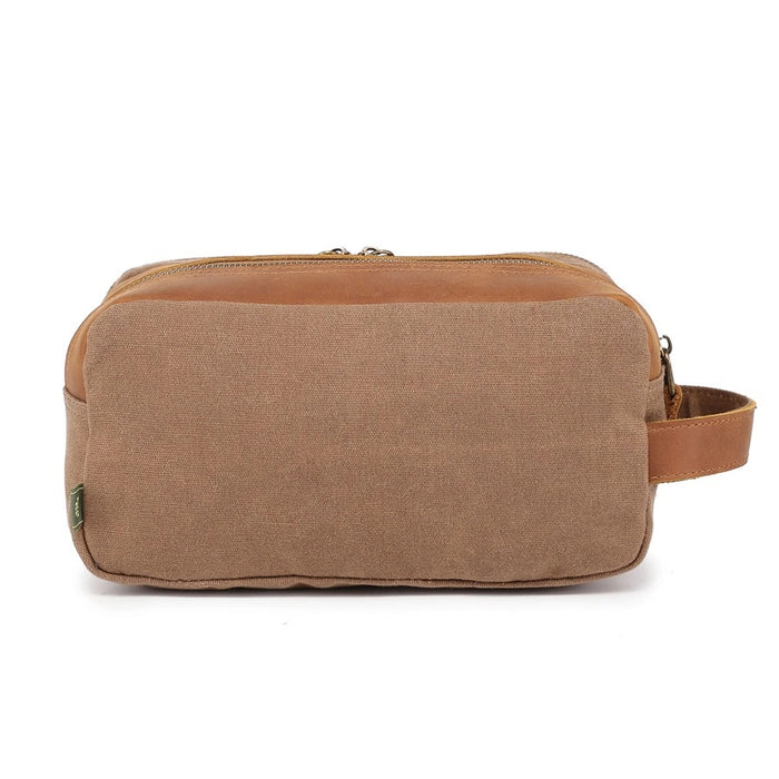 The TSD BRAND Turtle Ridge Toiletry Bag in khaki features leather accents, two zippered compartments, a side handle, and a small logo patch on the front pocket.