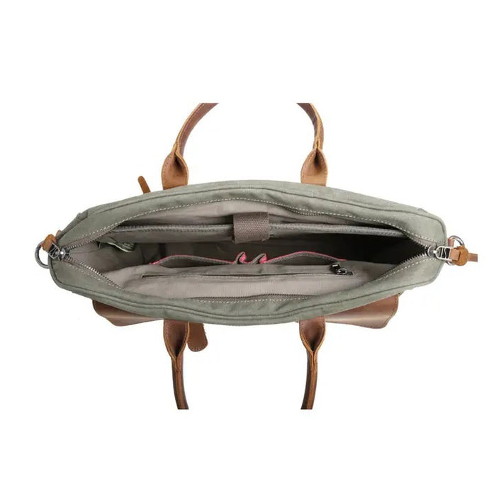 Top view of an open TSD BRAND - VALLEY HILL BRIEFCASE tote with brown leather handles, spacious interior, zip pocket, divider, and pink lining—a chic, sustainable TSD BRAND work bag for daily use.
