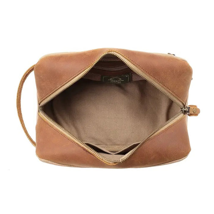 The TSD BRAND - VALLEY OAK TOILETRY BAG IN KHAKI is a handcrafted toiletry bag with a handle, shown open from above to reveal its empty beige fabric-lined interior—perfect for organized travel.