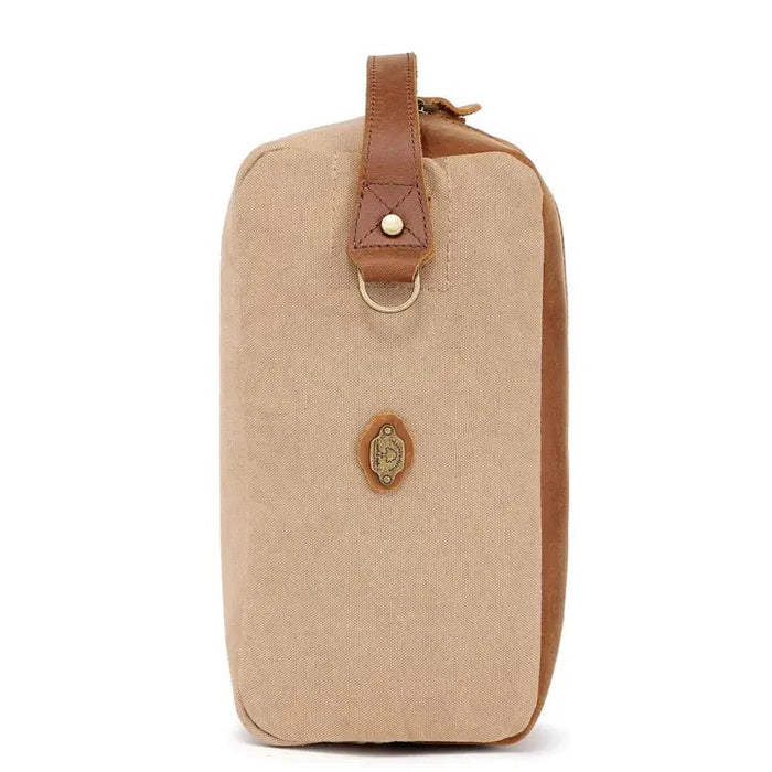 The TSD BRAND - VALLEY OAK TOILETRY BAG IN KHAKI is a handcrafted toiletry bag with a handle, shown open from above to reveal its empty beige fabric-lined interior—perfect for organized travel.