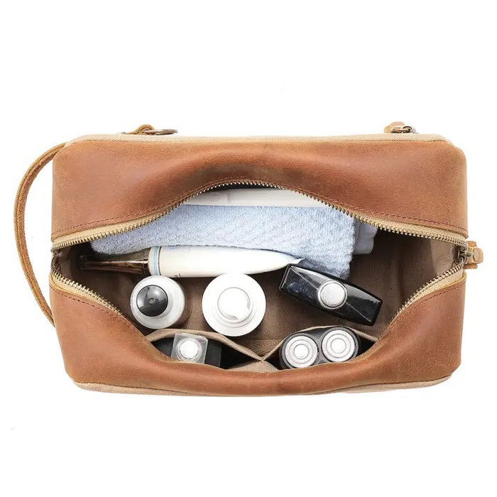 The TSD BRAND - VALLEY OAK TOILETRY BAG IN KHAKI is a handcrafted toiletry bag with a handle, shown open from above to reveal its empty beige fabric-lined interior—perfect for organized travel.