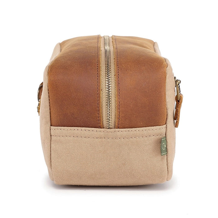 The TSD BRAND - VALLEY OAK TOILETRY BAG IN KHAKI is a handcrafted toiletry bag with a handle, shown open from above to reveal its empty beige fabric-lined interior—perfect for organized travel.