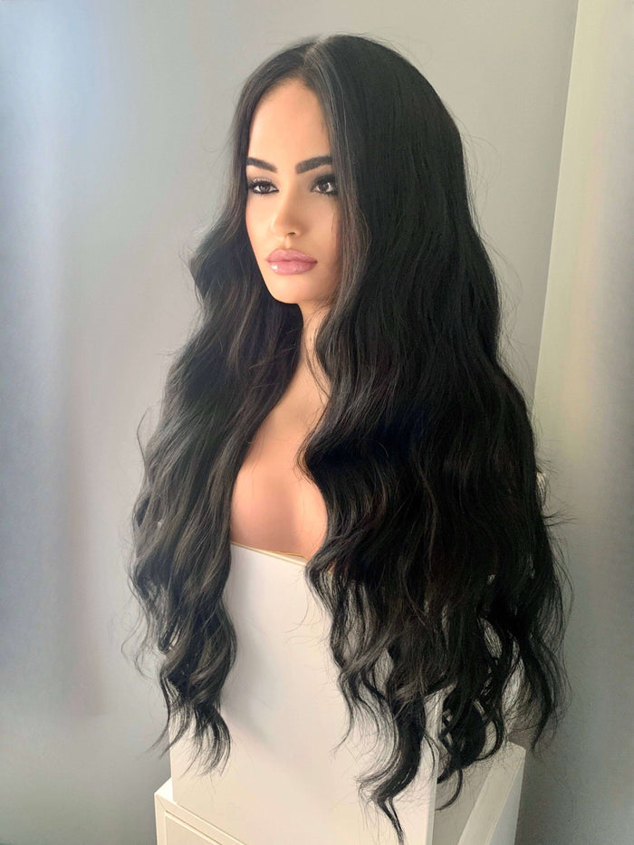 Valentina Long Black Soft Waves Wig displayed on a mannequin, showcasing elegant, flowing black waves with a natural center part.