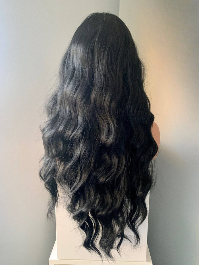 Long black soft waves wig displayed on a mannequin, showcasing elegant flowing waves.