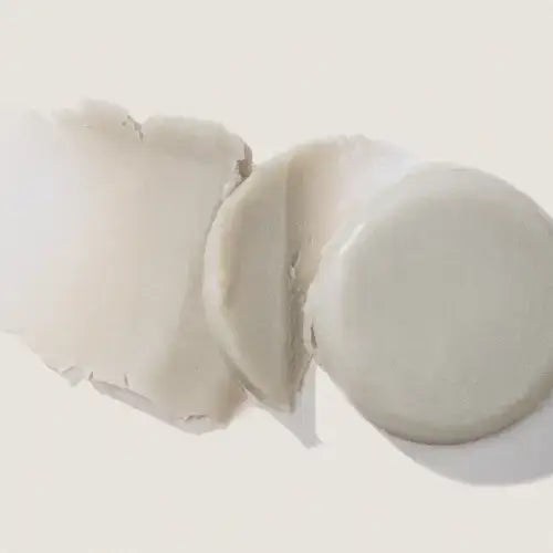 Broken white eggshell with yolk on a light background