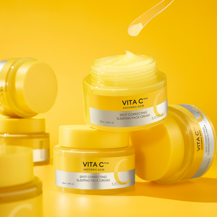 Yellow jars of Vita C skincare cream on a yellow background