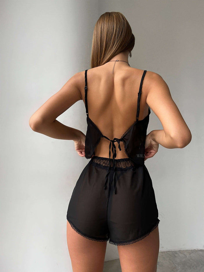 Model wearing WHISPER 2-Piece Mesh & Lace Set in black, showcasing back design and lightweight sheer fabric.