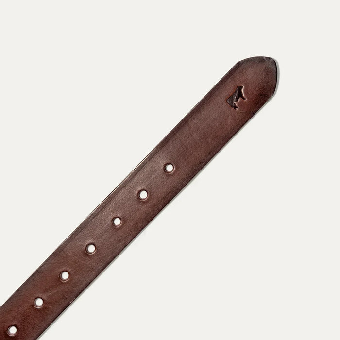 The WILL LEATHER GOODS - SADDLE BELT is a brown full-grain leather belt with a metal buckle and an embossed animal logo near the end, coiled on a plain white background—a timeless classic from WILL LEATHER GOODS for jeans.