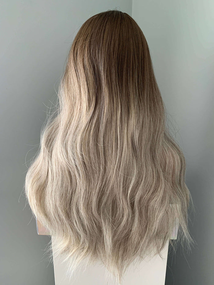 Back view of the Willow Long Wavy Grey Silver Wig showcasing loose waves and blended ash brown and blonde highlights.