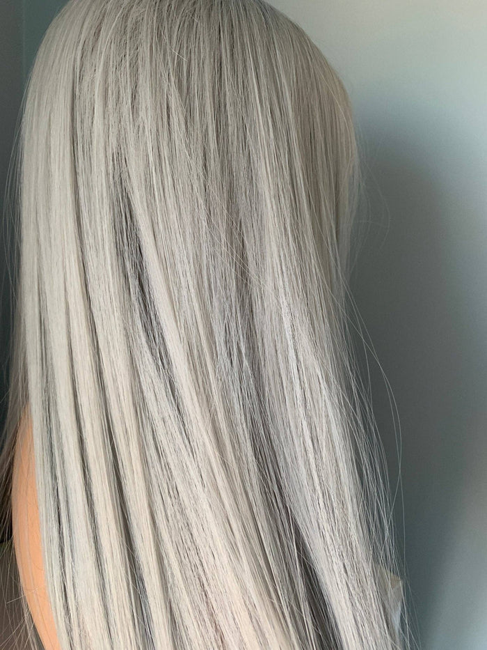 Long straight silver wig displaying sleek strands and a modern look, perfect for stylish transformations.