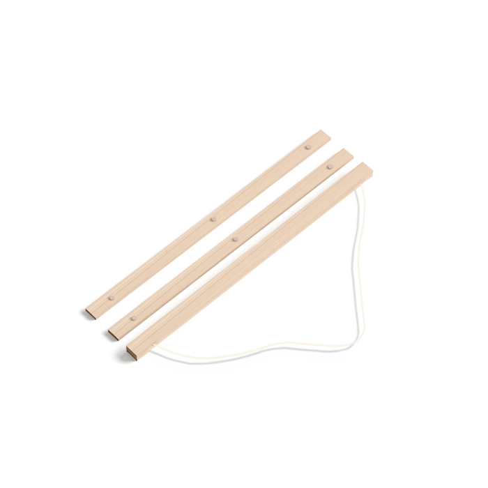 Two wooden sticks with a string on a white background