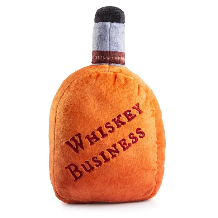 Introducing the WOOFFORD RESERVE BOURBON DOG TOY by HAUTE DIGGITY DOG—this plush dog toy is cleverly designed to resemble a whiskey bottle, complete with whimsical dog-themed text and a paw print on the label. Perfect for pups who enjoy playful style and cuddly fun!.